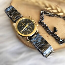 
ساعت رومانسون زنانه بنداستیل مشکی صفحه مشکی قاب طلایی همراه دستبند زنجیری مشکی