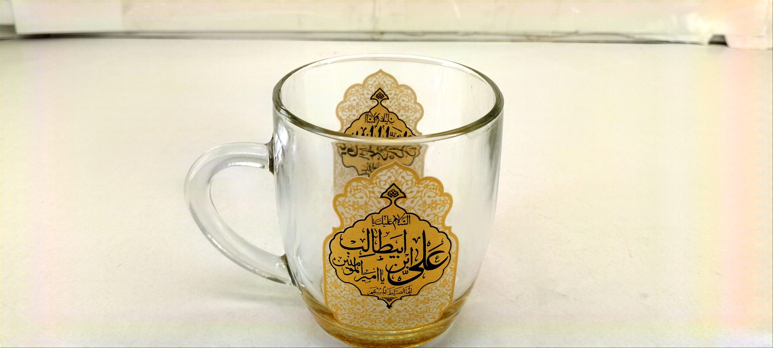 103444-لیوان شیشه ای دسته دار شفاف طلایی یا امیرالمومنین علی بن ابیطالب ع و یا فاطمه الزهرا س