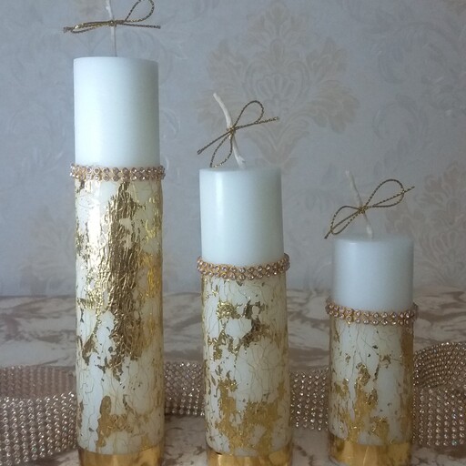 شمع استوانه 3 تایی تزئینی قابل اجرا در دو رنگ طلایی و نقره ای  وقطر  4 ، و ارتفاع 15 ، 10  و  5 سانت