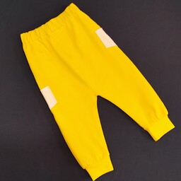 شلوار تک نوزادی رنگ زرد با جیب در سایزهای یک تا شش و ارسال رایگان