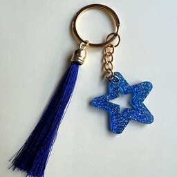 جاکلیدی رزینی دستساز طرح ستاره رنگ آبی همراه با منگوله ی کوچک