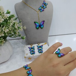 ست کامل پروانه رنگی آبی بنفش شامل گردنبند چهارپروانه،دستبند پنج پروانه،گوشواره سه پروانه  و گیرمو و انگشتر 