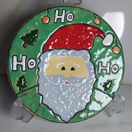 دیوارکوب و بشقاب 15 سانت طرح بابانوئل رنگ زمینه سبز فیروزه ای میناکاری  جنس سفال لعاب خورده و قابل شستشو