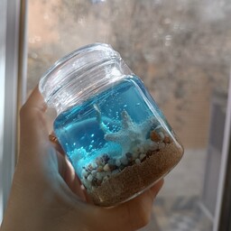 شمع دریایی ،شمع ژله ای طرح دریا با صدف های طبیعی و ستاره دریایی رنگ آبی روشن