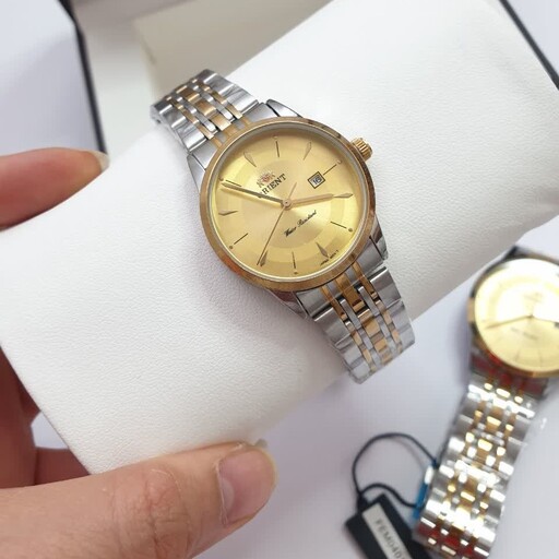 ساعت ست اورینت زنانه و مردانه بند استیل صفحه طلایی همراه با دستبند با گارانتی و تقویم 