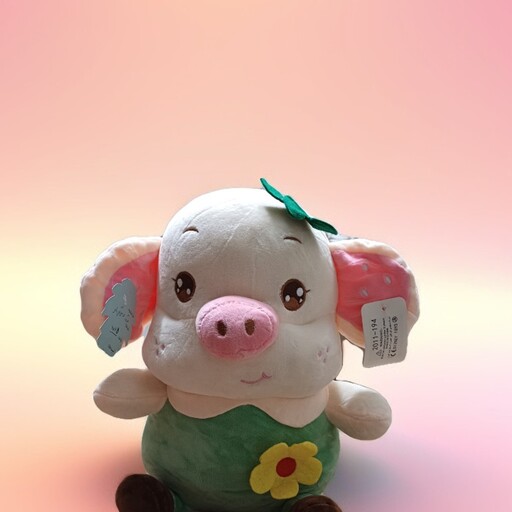 عروسک خوک لباسدار سبز رنگ گل دار .