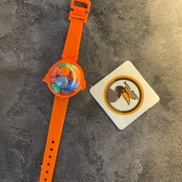 ساعت اسمارتیز رنگ نارنجی خوشگل و خوشمزه با بند پلاستیک