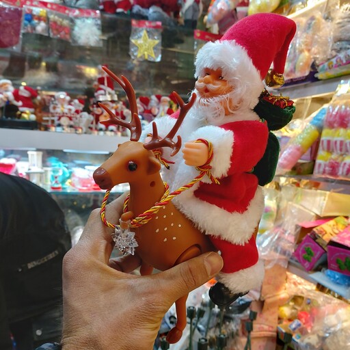 عروسک بابانوئل گوزن سوار  موزیکال متحرک چراغدار