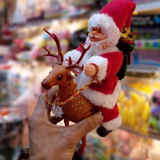 عروسک بابانوئل گوزن سوار  موزیکال متحرک چراغدار
