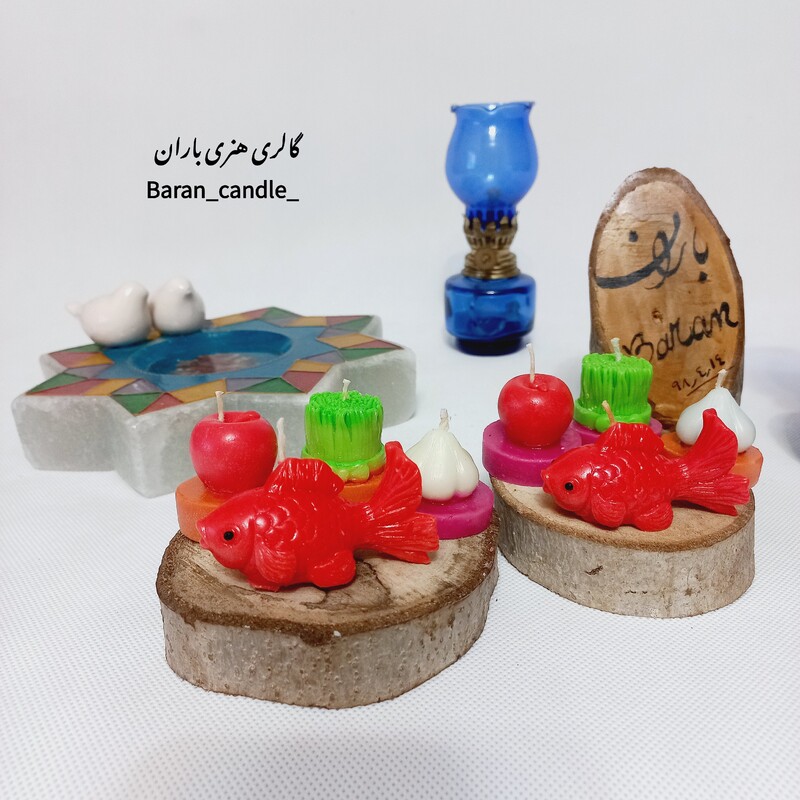 شمع دست ساز هفت سین (سبزه،سیر،سیب و ماهی) با کفه ی تنه ی درخت مناسب عیدی و هدیه