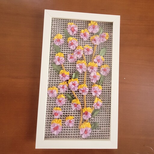 تابلو روباندوزی شده  با گل های بنفشه  با قاب وشیشه  دارای سی گل وده برگ  وقابل سفید وبسیار شیک وزیبا است
