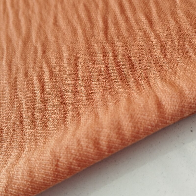 پارچه ی بنتون ابروبادی جنس خوب عرض 150 درجه ی یک تک رنگ رنگ نارنجی  قیمت به ازای نیم متر 