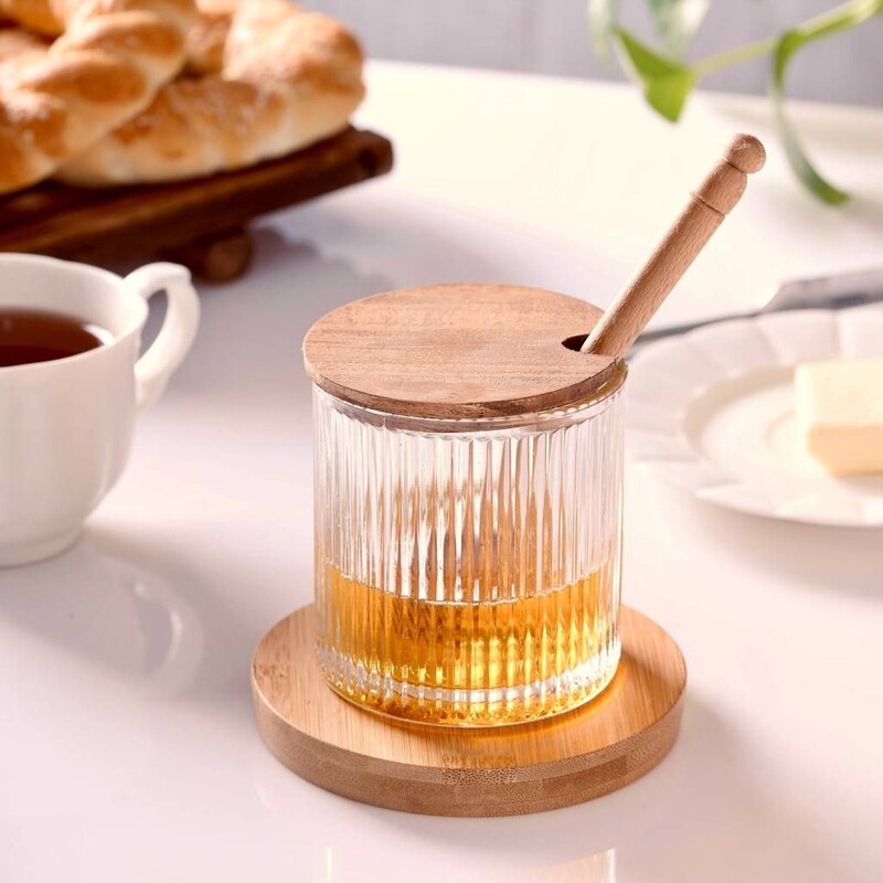 عسل خوری شیشه ای همراه با قاشق چوبی