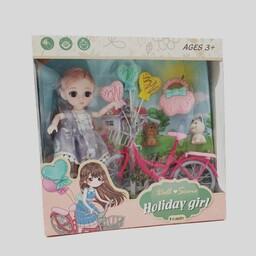 عروسک دختر چشم تیله ای با دوچرخه