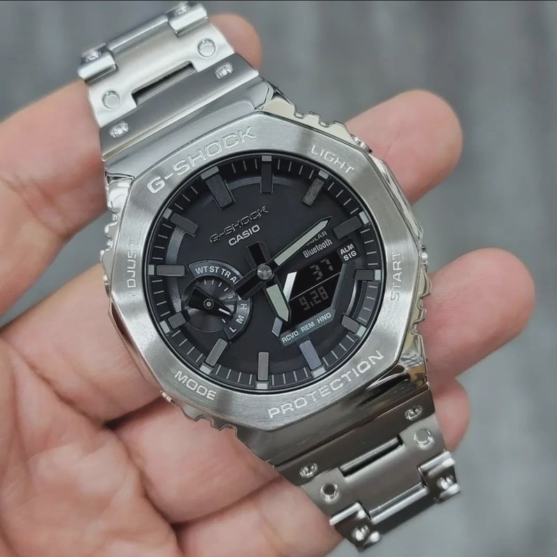 ساعت مچی کاسیو جی شاک مدل GM-B2100D-1ADR بند فلزی (جیشاک GShock) تنظیم اتوماتیک با پایتخت کشورها،اتولایت