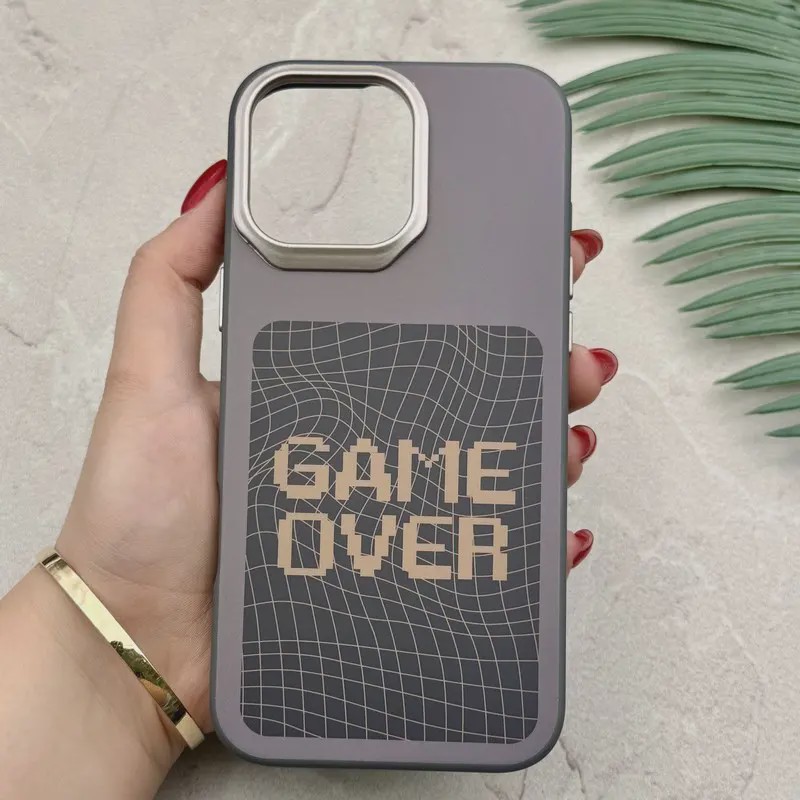 قاب گوشی iPhone 16 Pro Max آیفون فانتزی اسپرت HARD لنز سیلور طرح GAME OVER کد 156650
