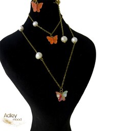 ست زنانه استیل طلایی طرح پروانه نارنجی و مروارید پرورشی گردنبند دستبند گوشواره