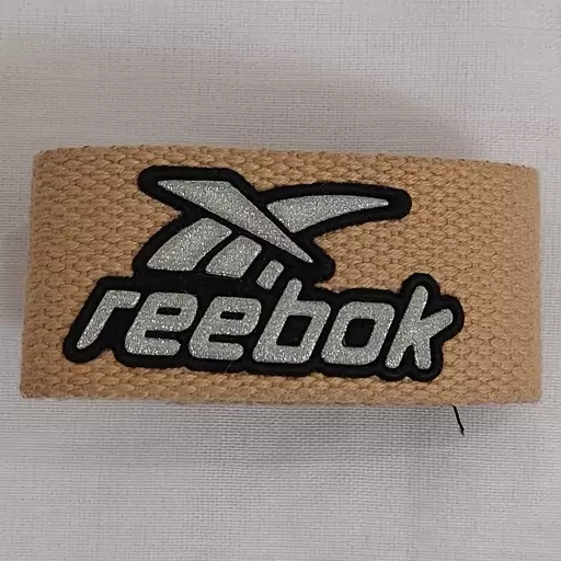 دستبند یا مچ بند اسپرت ورزشی طرح ریبوک reebok مدل چسبی رنگ کرمی اکسسوری زنانه مردانه