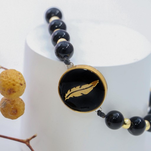 دستبند فریم دار طرح پر با پوشش طلا
