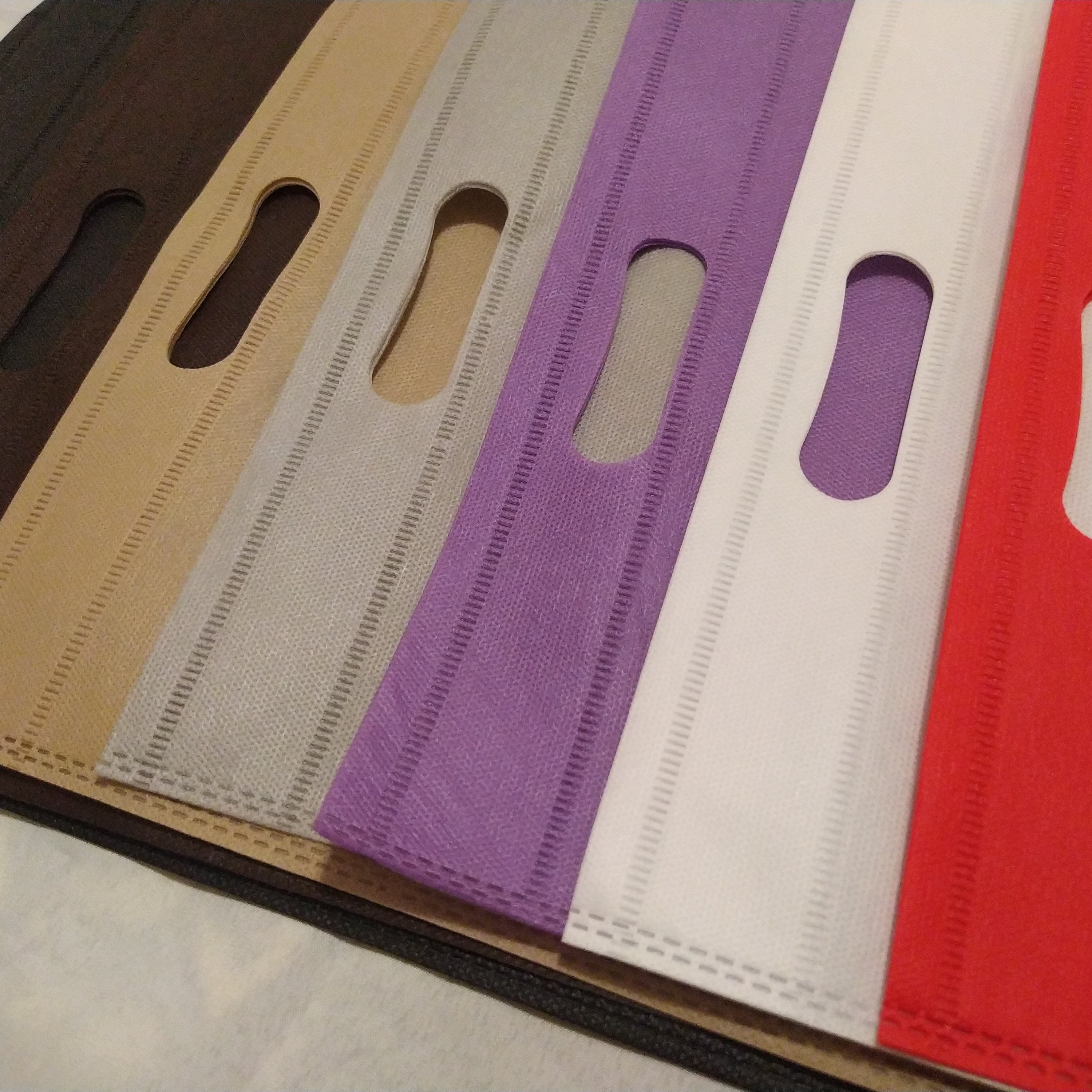 بسته 500 و 1000 عددی ساک دستی سوزنی 30-40 دسته پانچ  60 گرم 