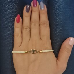 دستبند زنانه طلا 18 عیار طرح چشم با بند سفید