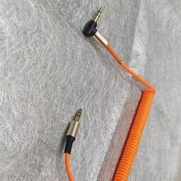کابل فنری AUX طول یک متر دارای محافظ آهنی در دو سر کابل فقط رنگ نارنجی موجود